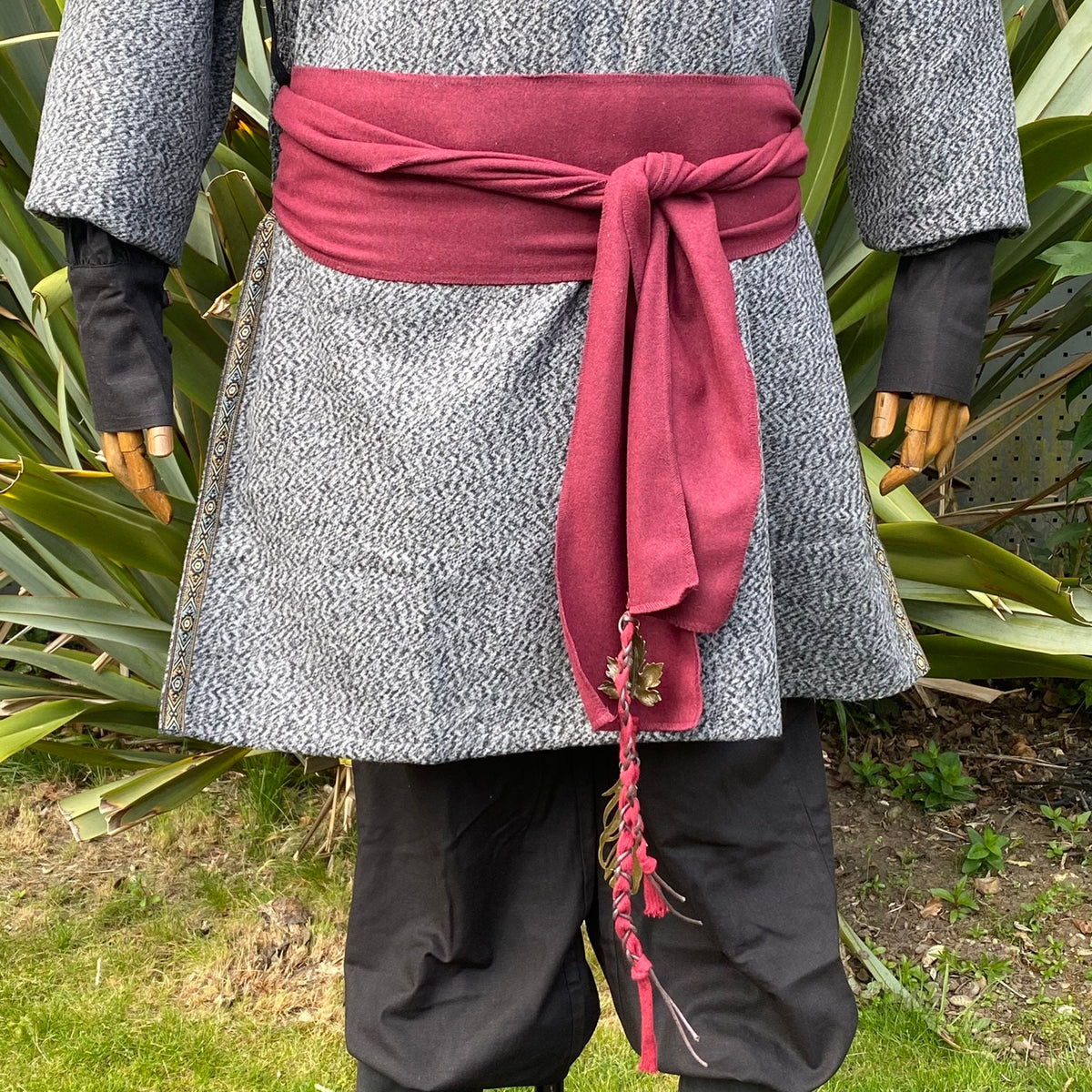 Medieval LARP sash in purple wool tied with leaf embellishments.