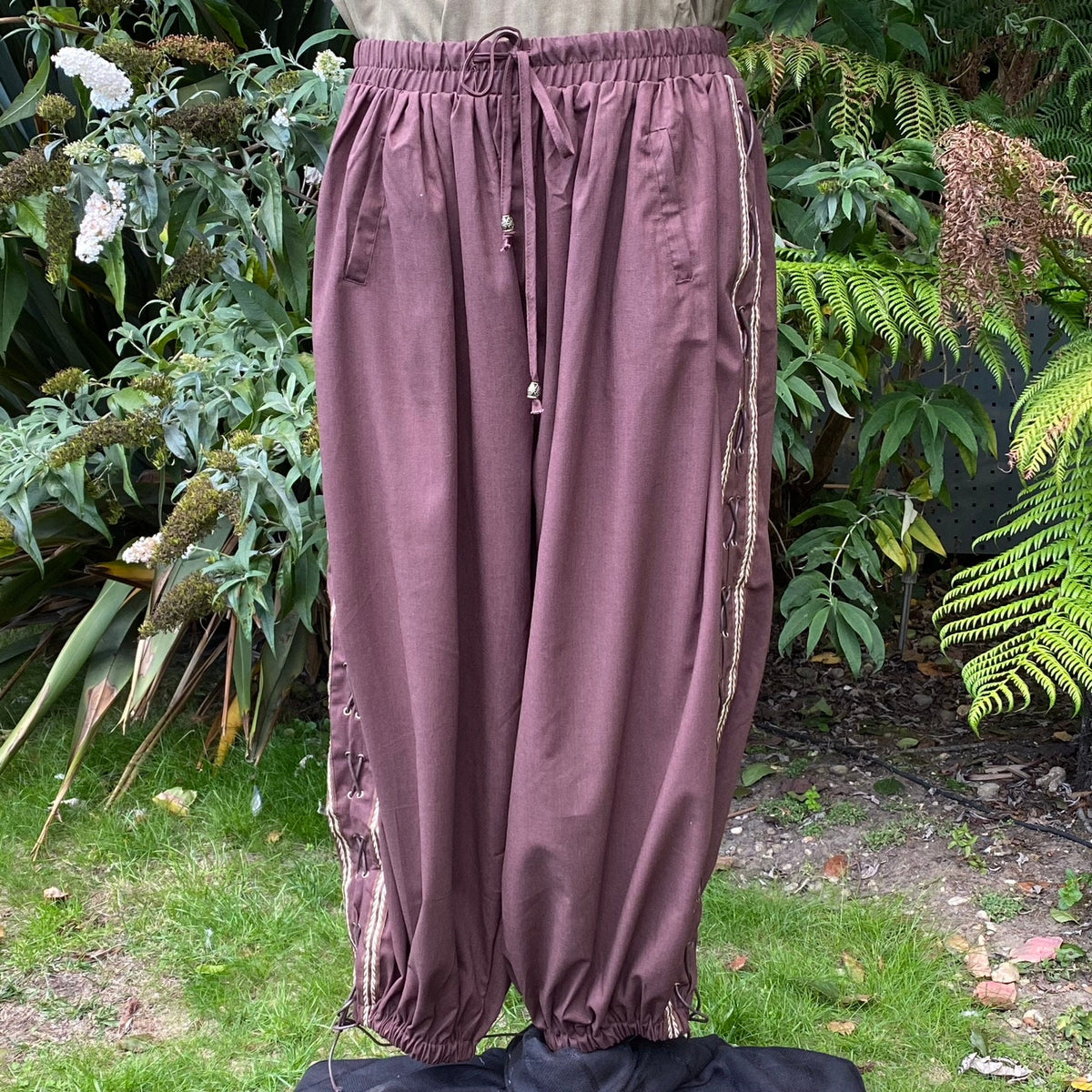 Loose brown LARP pants with side braid detail.