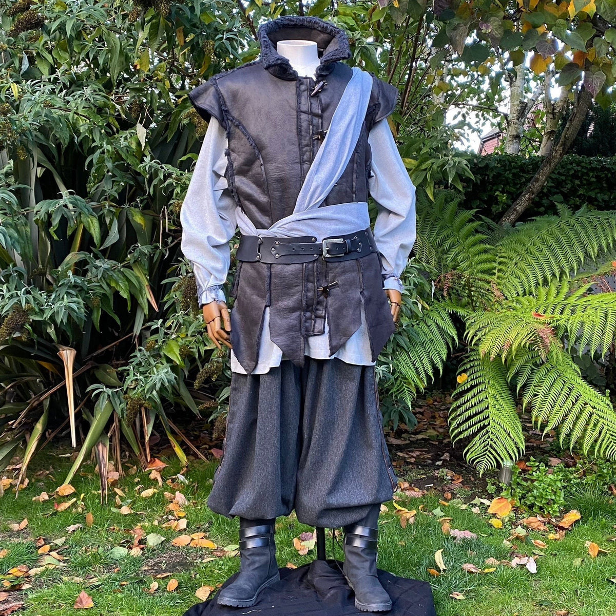 Medieval LARP outfit front view, featuring a black waistcoat, grey cotton shirt, trousers and sash.