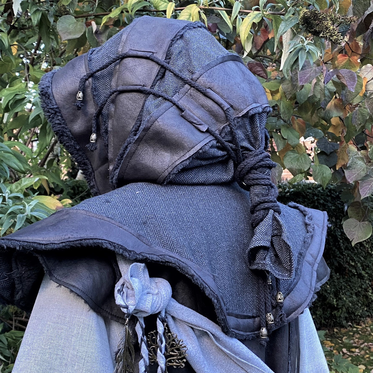 Layered LARP hood with rope details and decorative beads, back view.