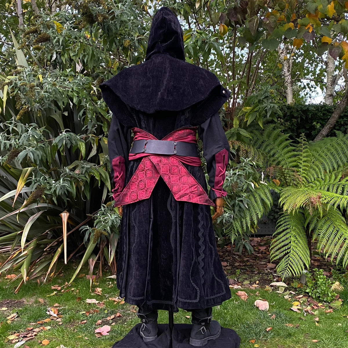 Back view of LARP blood mage black cloak, red waist accent.
