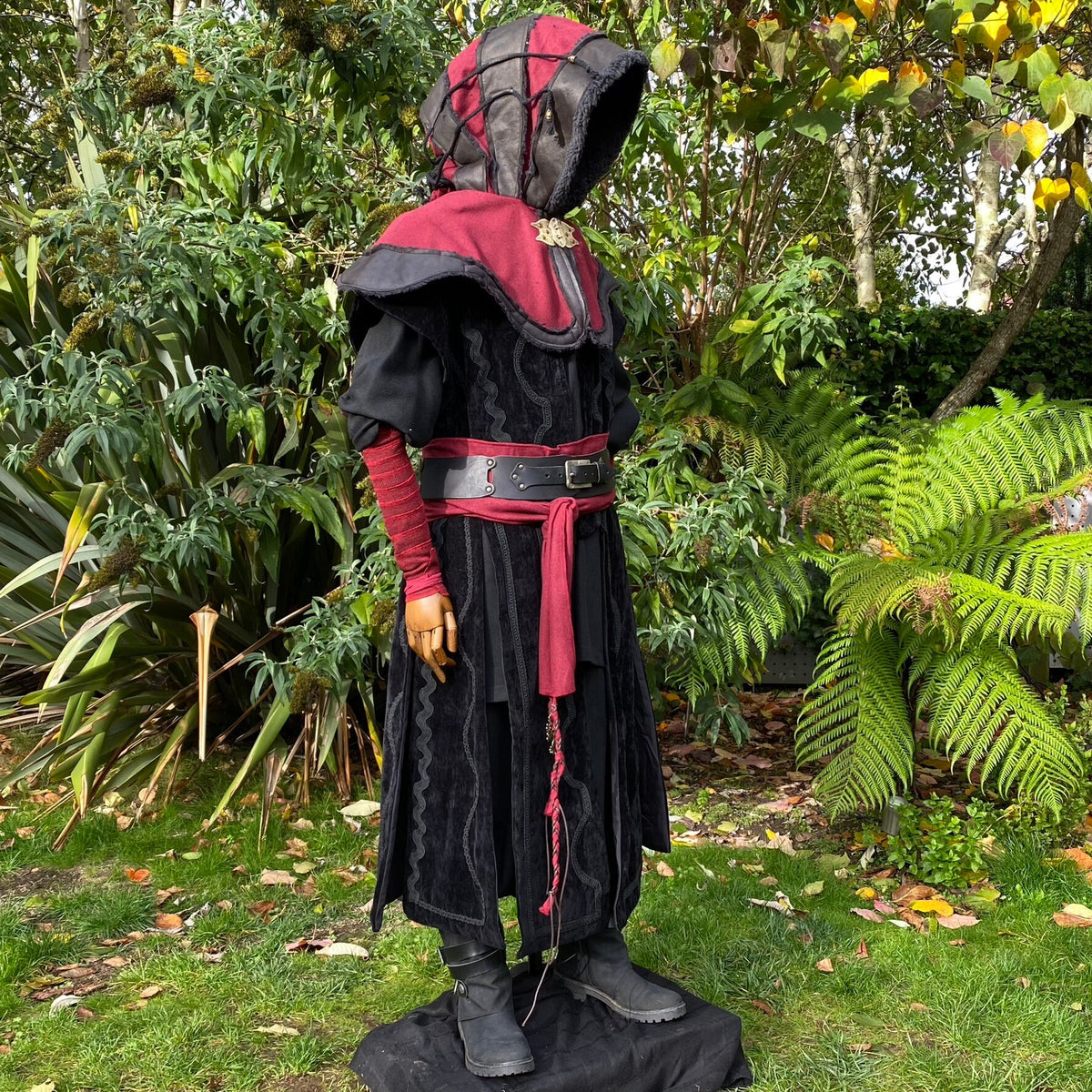 LARP costume with red accents, side view of hooded cloak and wrapped belt.
