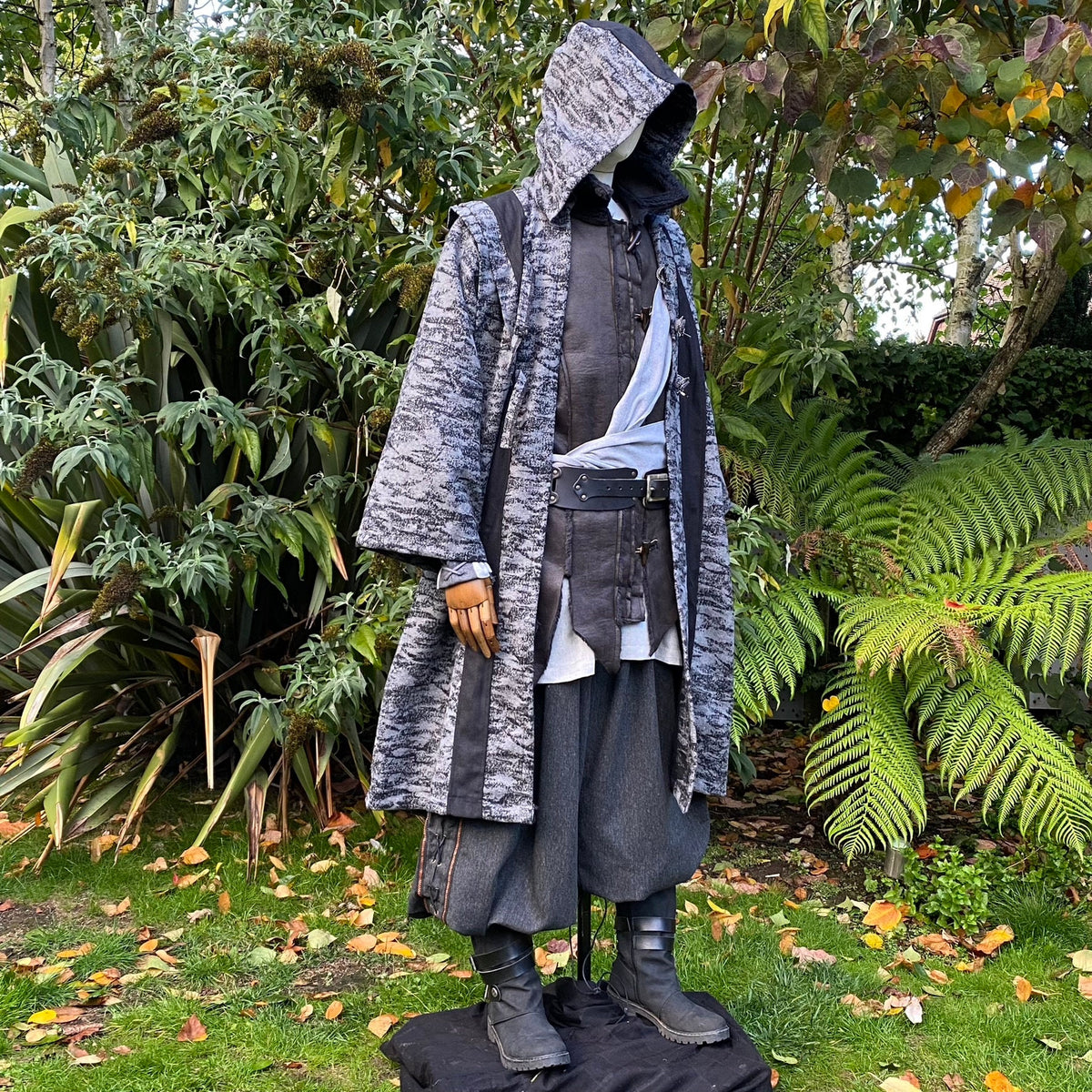 Medieval LARP costume side view, featuring grey and black hooded robe, and a grey woollen.