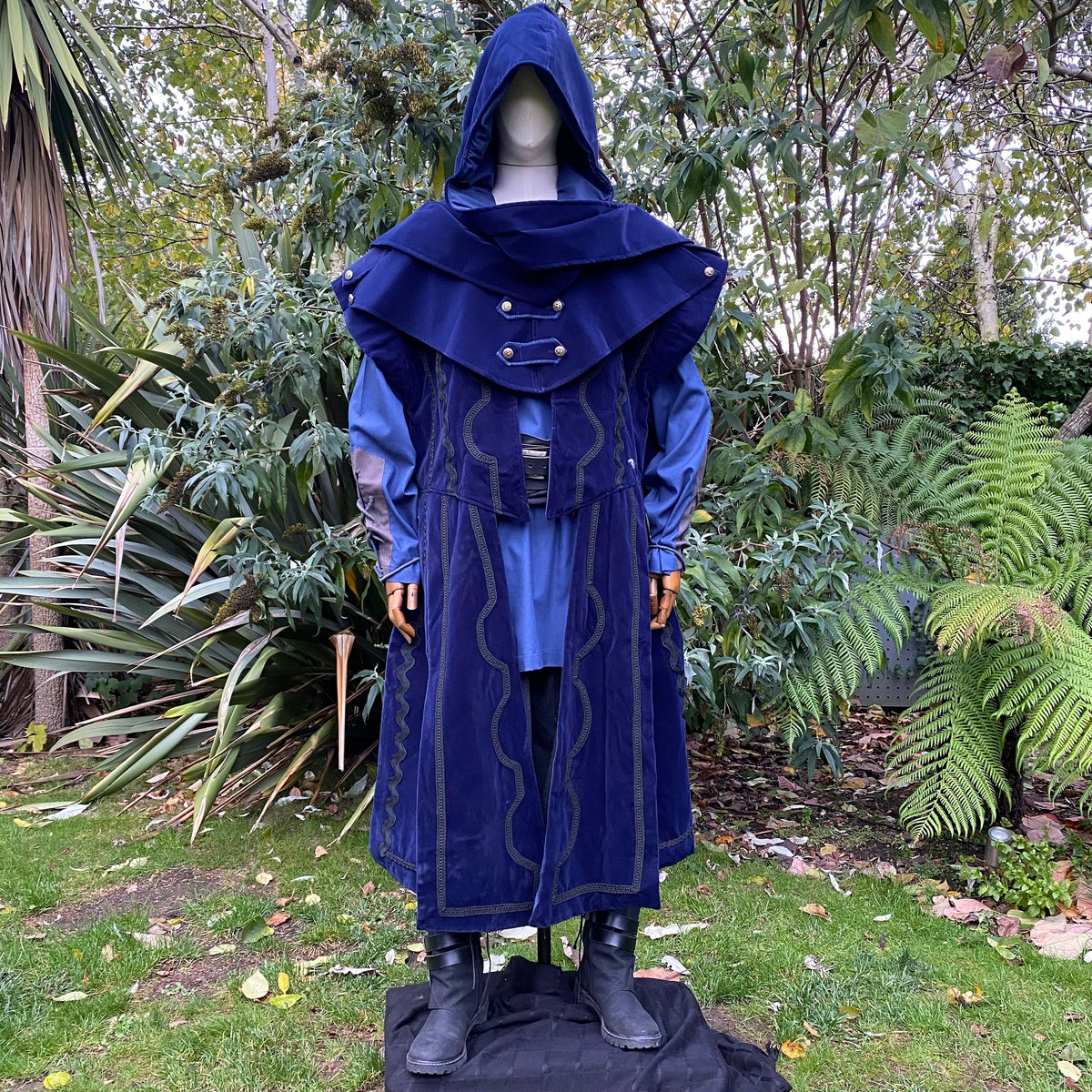 Hooded LARP outfit in blue suede effect, front view with forest backdrop.