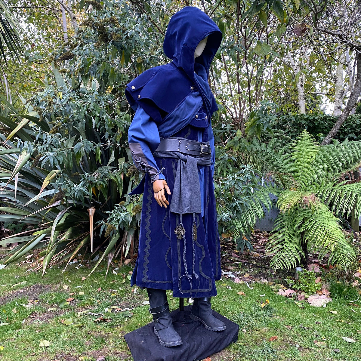 Side view of hooded azure LARP outfit with ornate medieval designs.