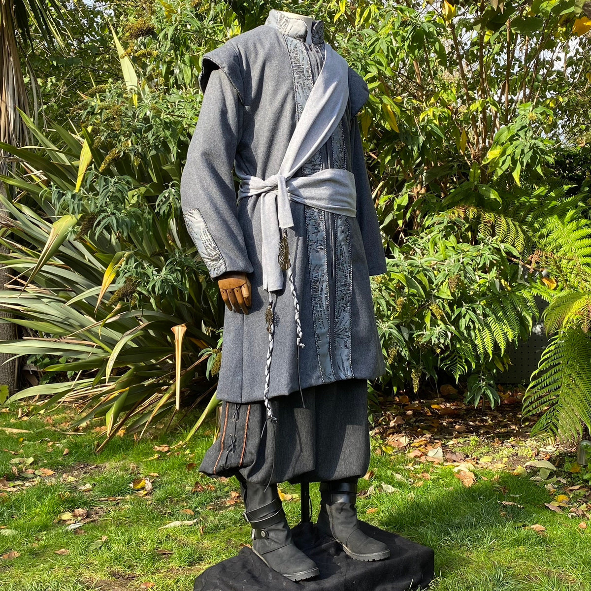 Grey LARP coat side view with embroidered cuffs.