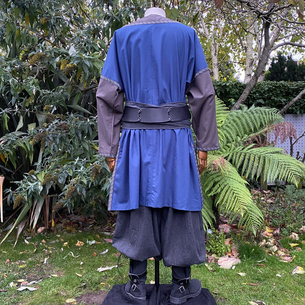 Medieval LARP outfit back view, featuring a blue and grey tunic, trousers, and sash. For Renaissance Faire and historical roleplay events.