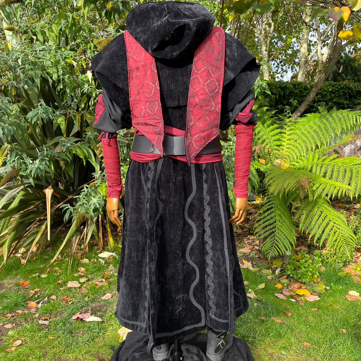 Back view of black-red medieval LARP outfit with hooded waistcoat detail.