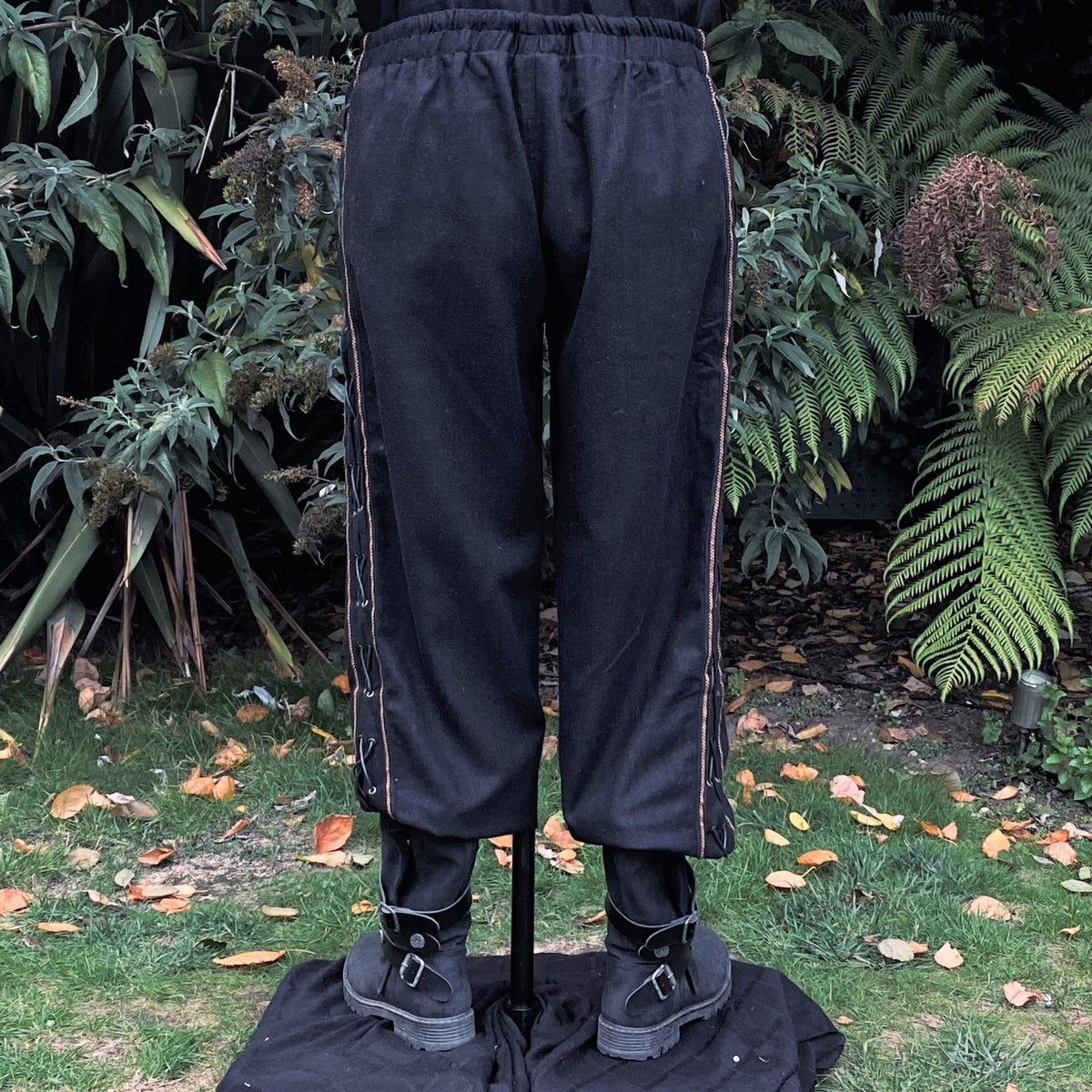 Rear view of medieval LARP trousers with side lace detail.
