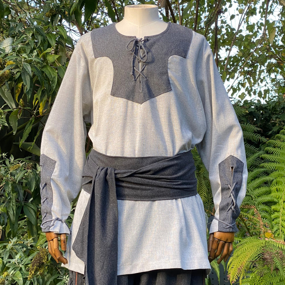 Viking shirt with dark grey details and sash for LARP, front view.