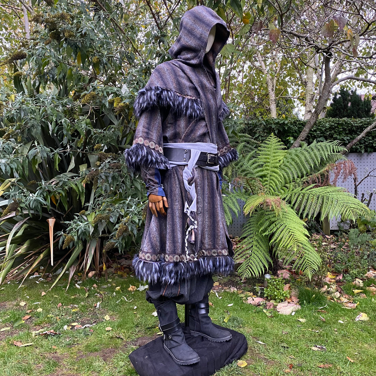 Medieval LARP outfit side view, featuring a blue and grey fur trim tunic, matching hood.