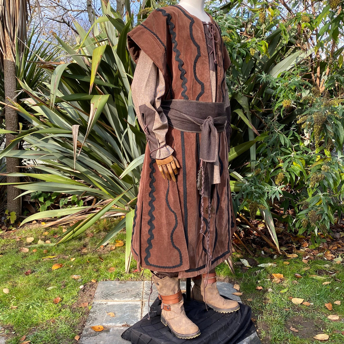 Side view of brown suede medieval waistcoat with black braid, LARP costume.