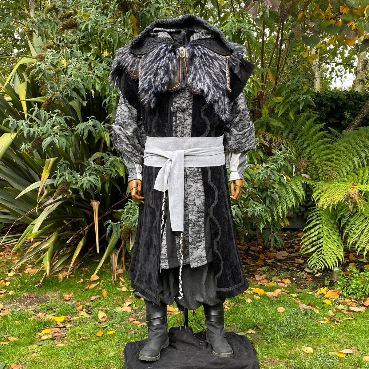 Medieval LARP outfit with ornate hood and sash.