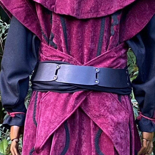 Back view of a black leather belt over a burgundy medieval-style robe in LARP setting.