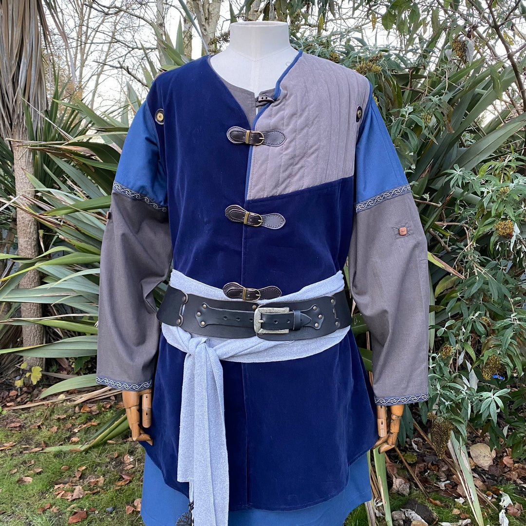 This LARP Gambeson Jacket comes in Blue & Grey Faux Suede. The LARP Armor has Removeable Sleeves that attach at the shoulder. The Padded Armor is warm and water resistant. This Jacket is perfect for your LARP Costume and LARP Character, Cosplay Events, and Ren Faires.