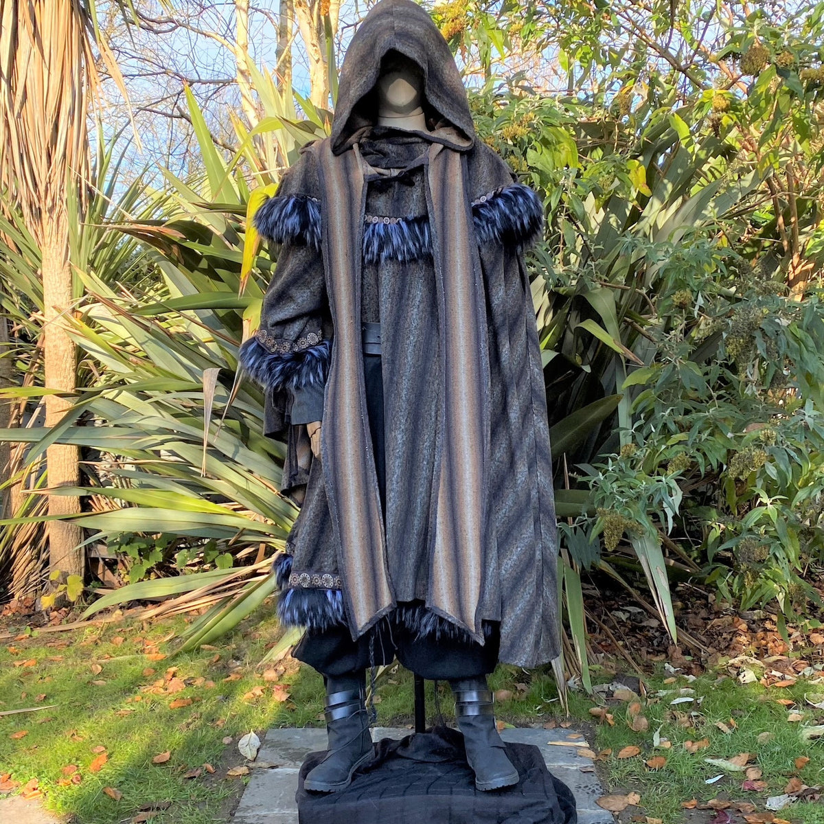 Medieval LARP outfit with a feather-trimmed cloak and hood.