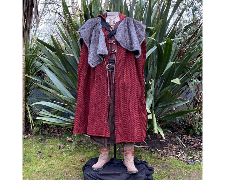 The Four Way LARP Cloak in Red Herringbone Wool with Reversable Grey Faux Fur & Leather Brown Mantle is a Versatile Cape with Hood. The Medieval Cloak is Water Resistant and helps keep you warm. The Viking Style Cloak can be worn in four ways; perfect for your LARP character, Cosplay Events, and Ren Faires. 