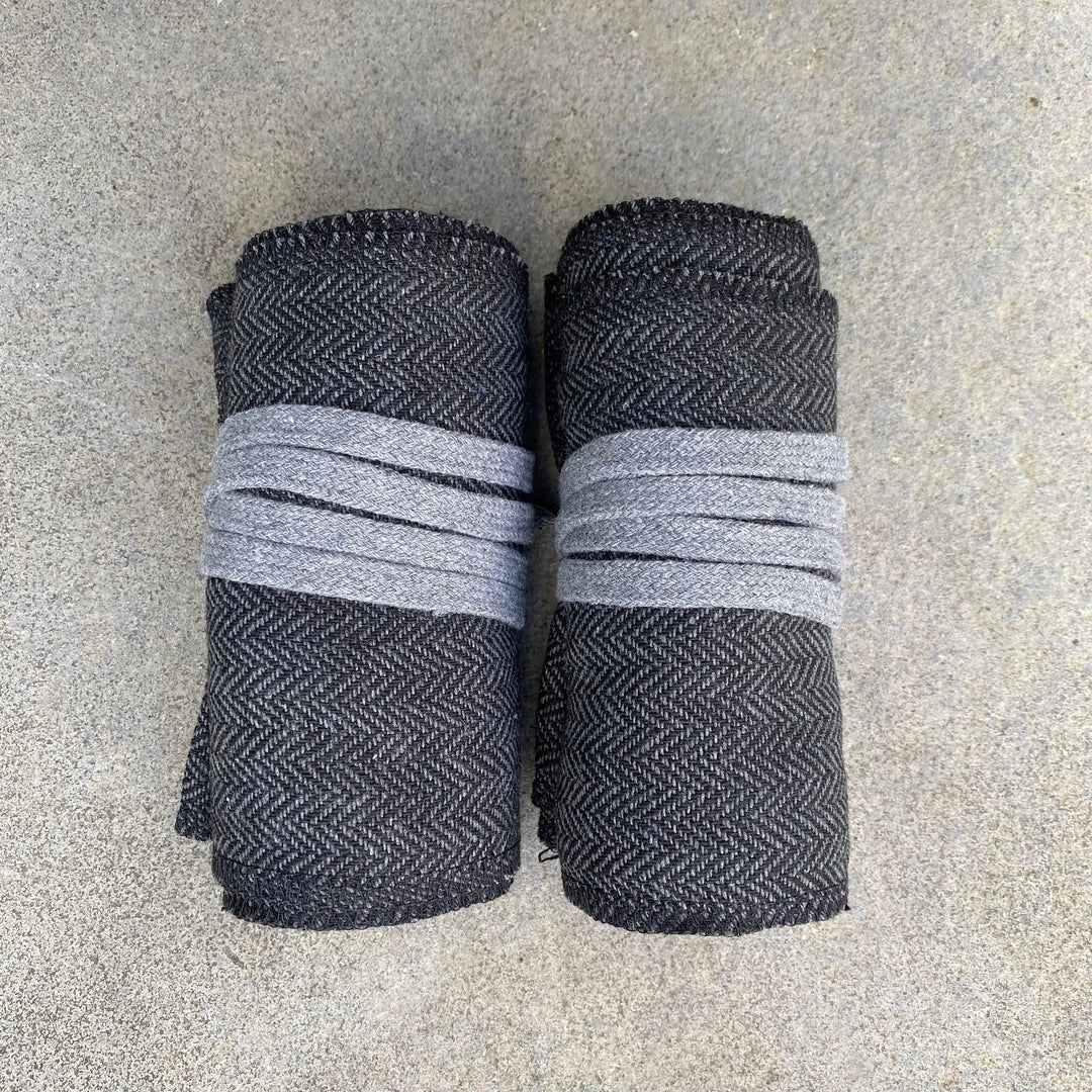 Set of Medieval LARPing Leg Wraps. They are Dark Grey and made out of a Herringbone Wool mixture which are used to keep Trouser flares out of the way and legs warm. These Viking Wraps can wrap around your Legs to provide an extra flare to LARP kit.