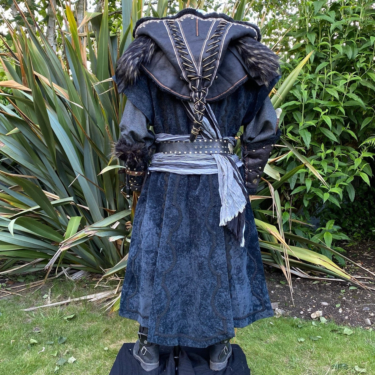 Dark medieval LARP set with hood, scarf, and vambraces, back view.