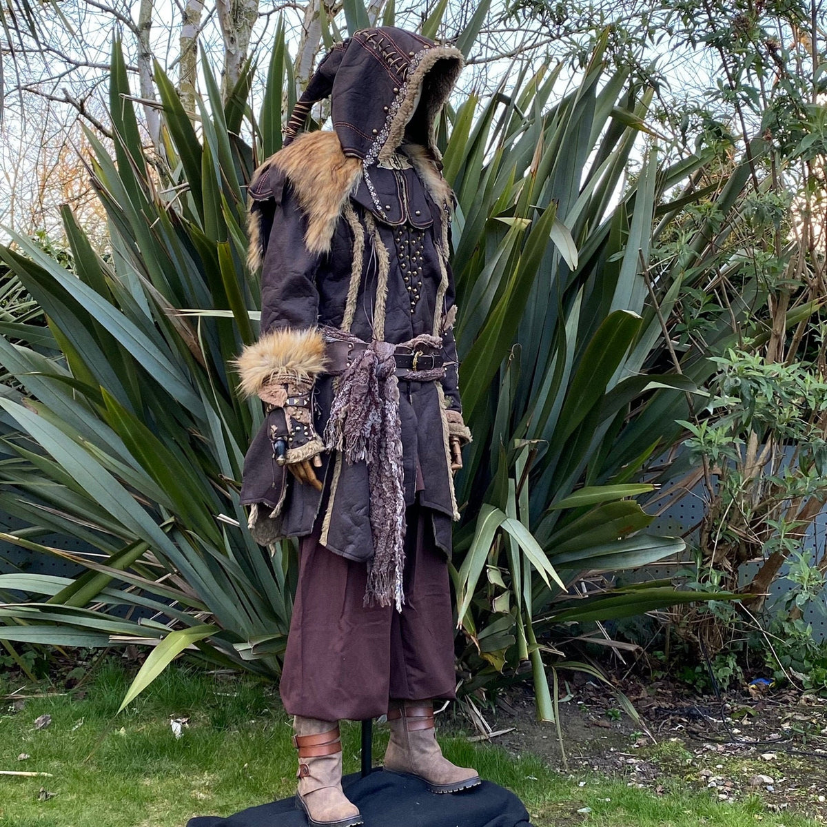 Side view of LARP medieval costume with fur-trimmed hood and detailed vambraces.