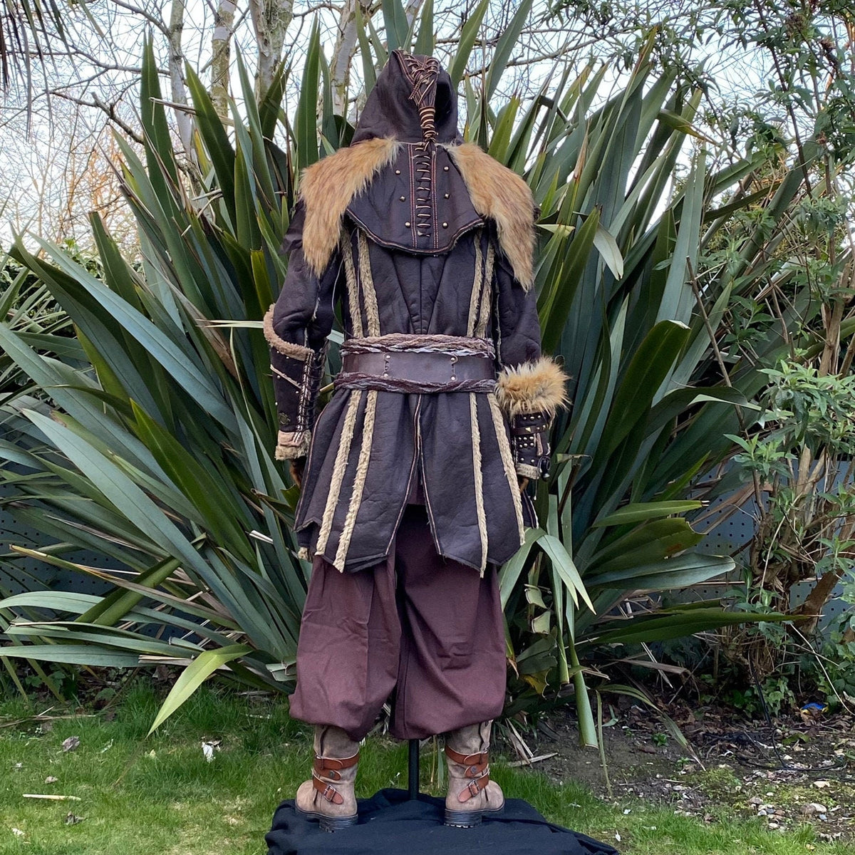 Back view of a medieval LARP outfit highlighting fur-trimmed sleeves.