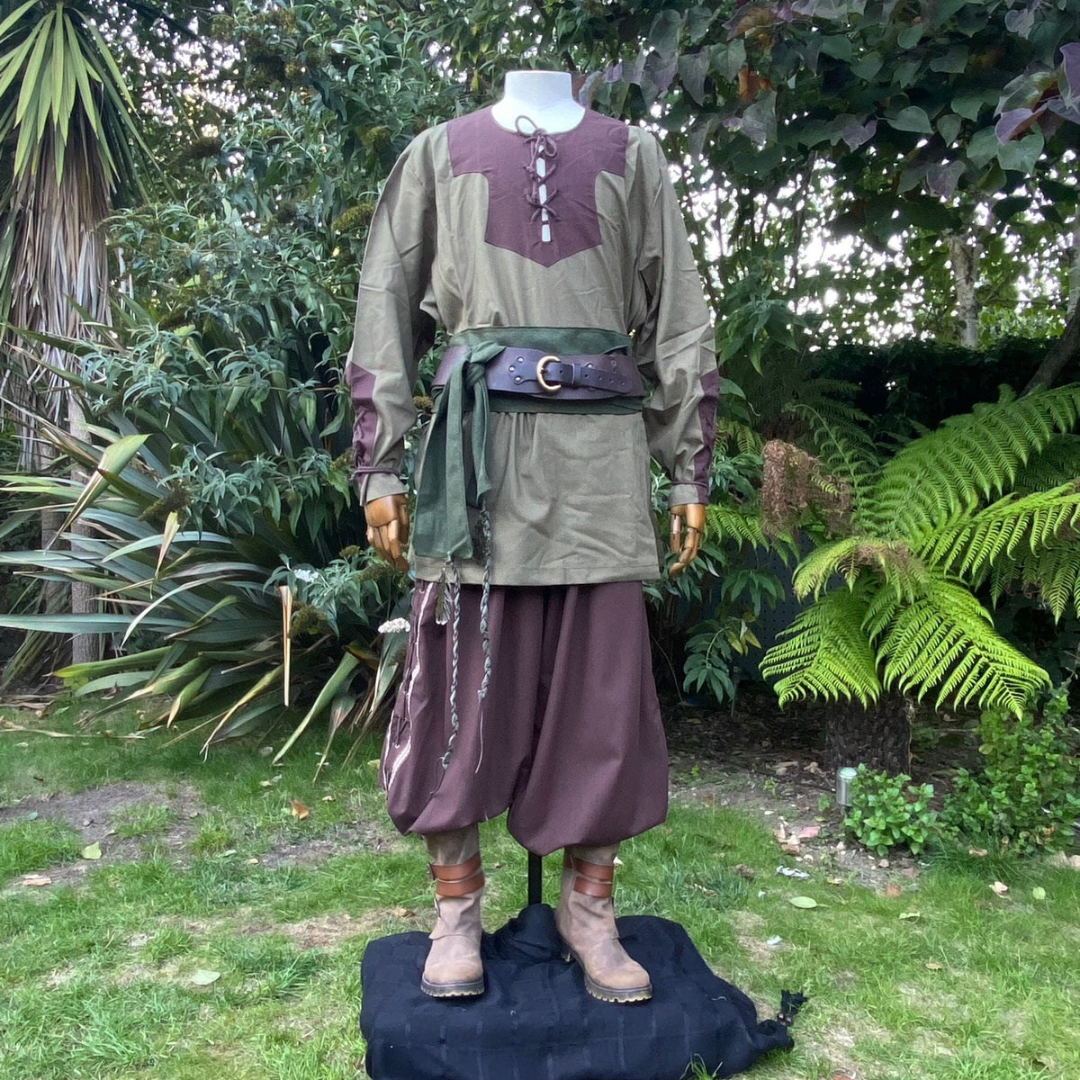 Medieval LARP outfit with brown pants, green shirt, and belt.