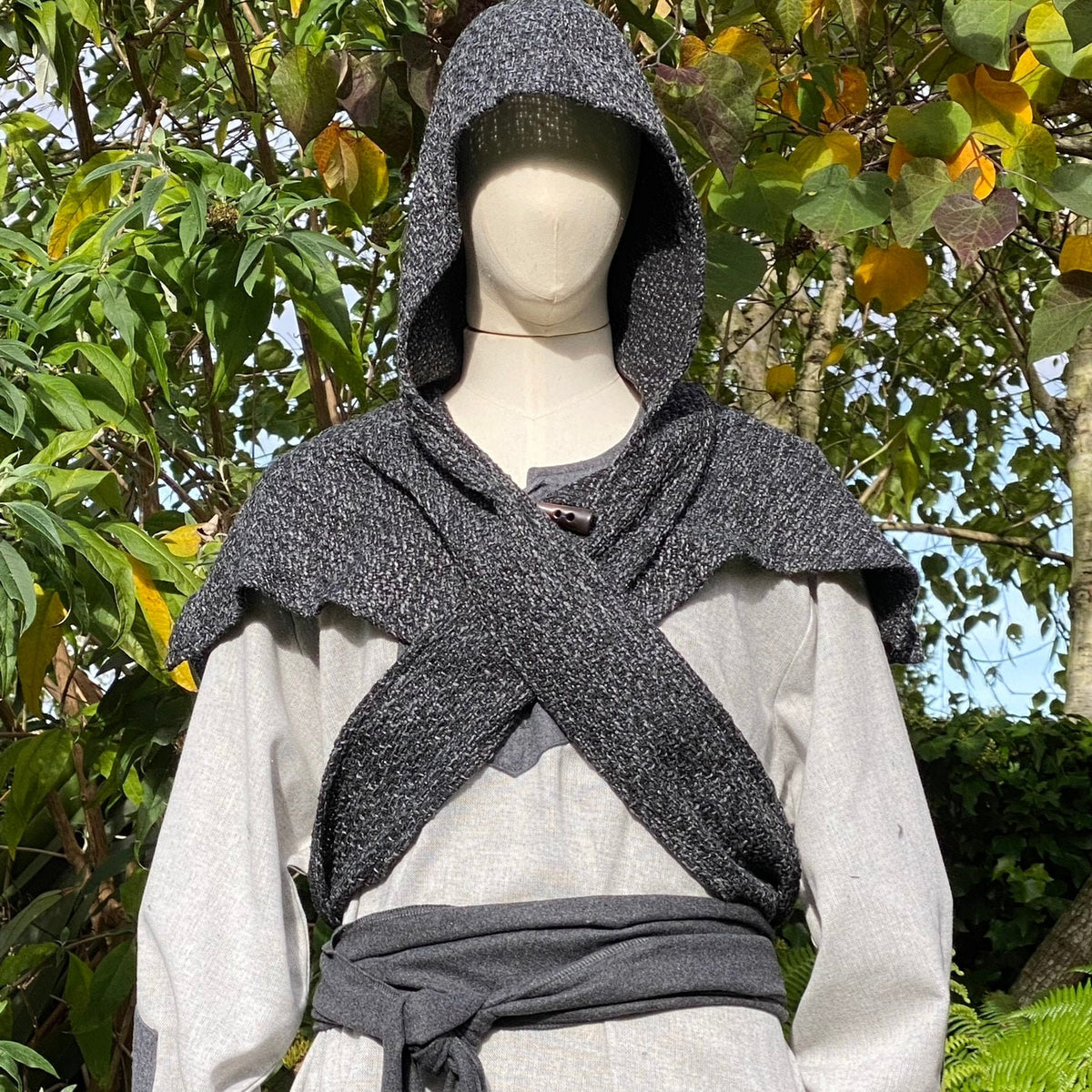 Viking LARP outfit, grey cross-hatched mantle, hood up.