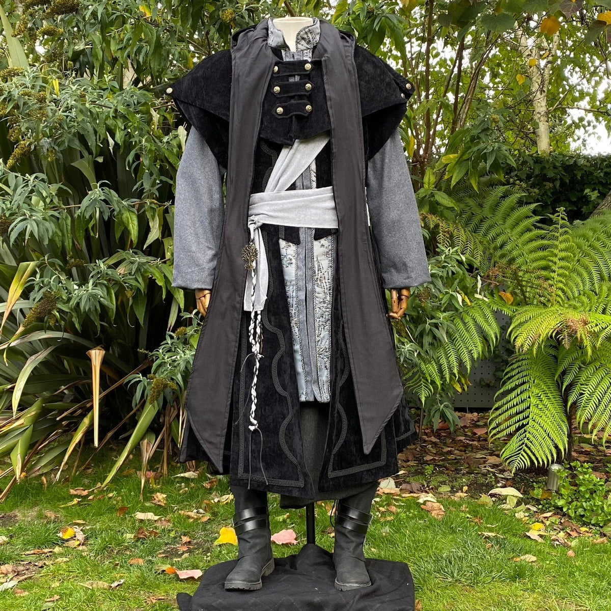 Mannequin in dark medieval outfit with cloak and sash.