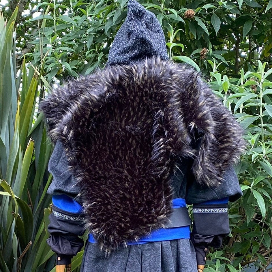 Medieval LARP outfit back view, featuring a grey wrap-around hood, and black and brown faux-fur.