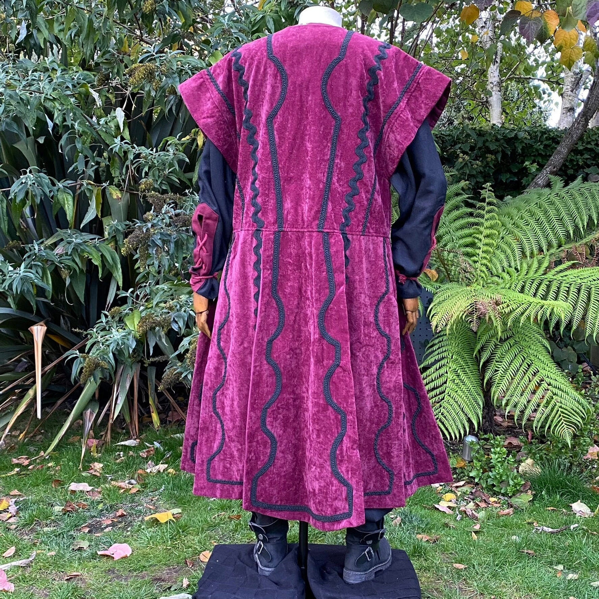 Back view of red medieval waistcoat with black braid detail for LARP.