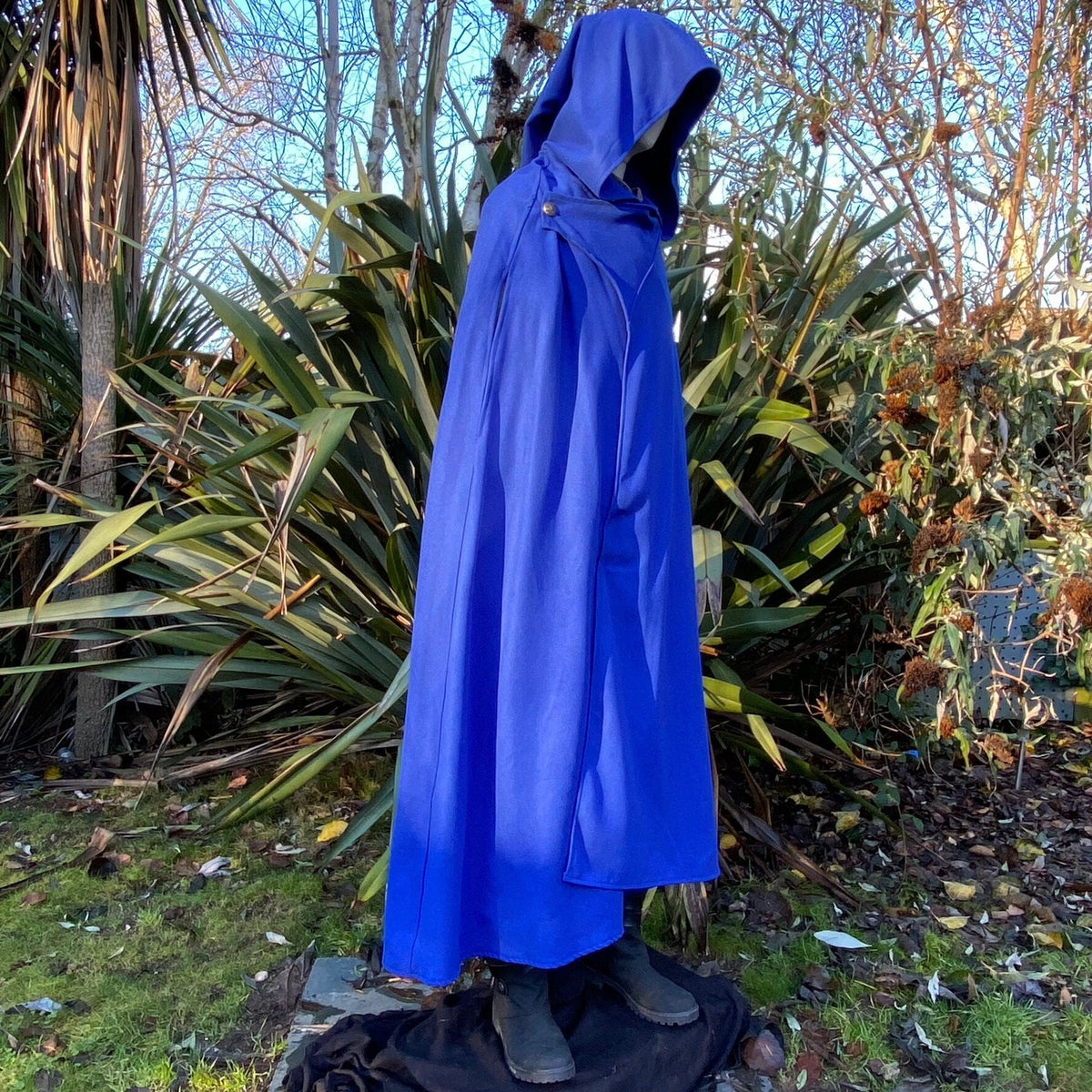 Side view of blue medieval LARP cloak with hood.