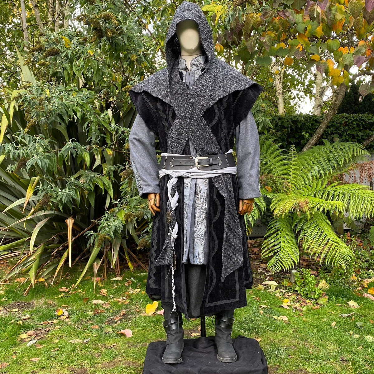 Hooded figure in medieval LARP outfit with grey and black layers.