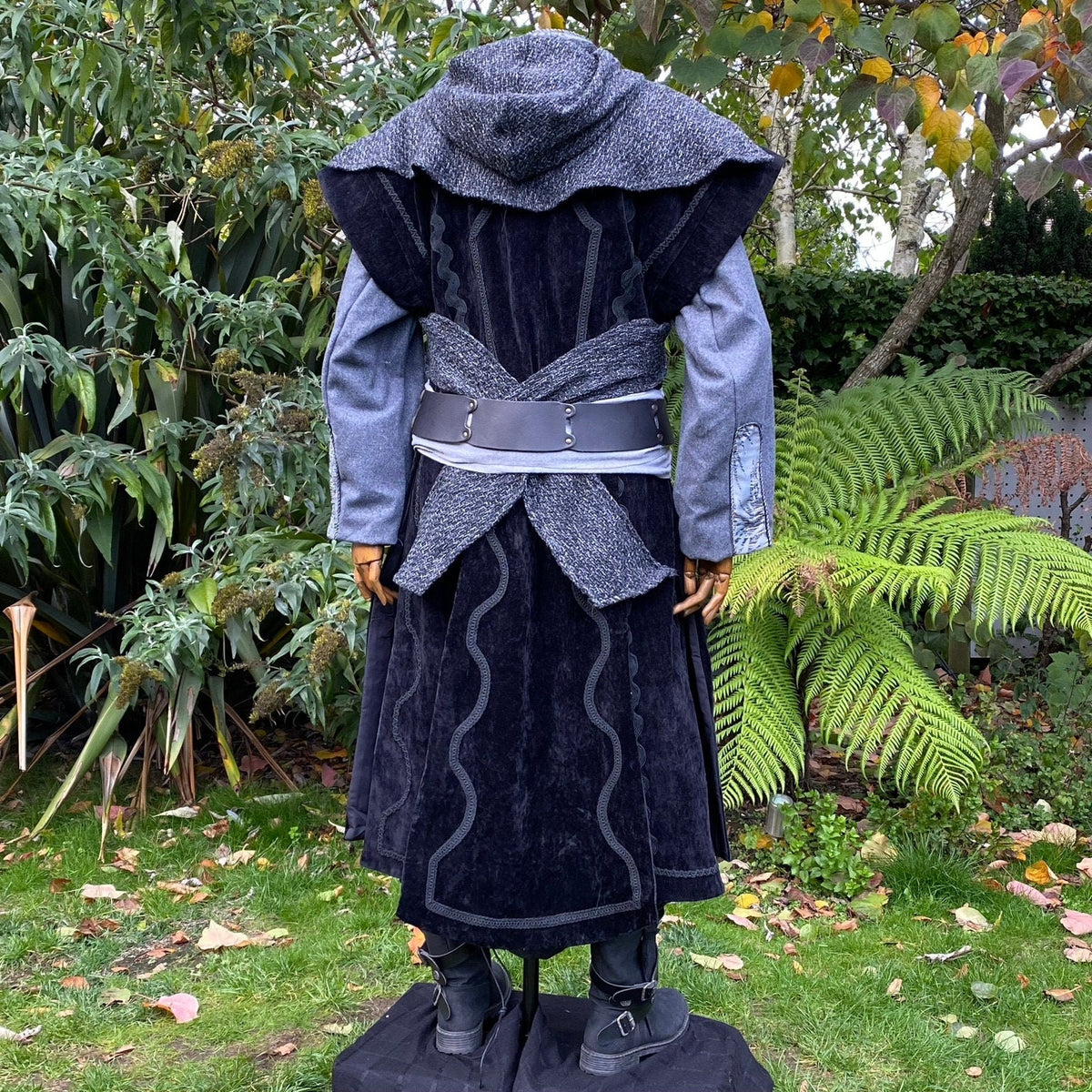 Back view of medieval LARP outfit with grey hood, belt, and flowing texture.