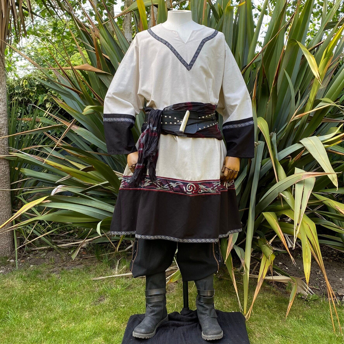 Medieval LARP outfit with embroidered tunic, grass background.