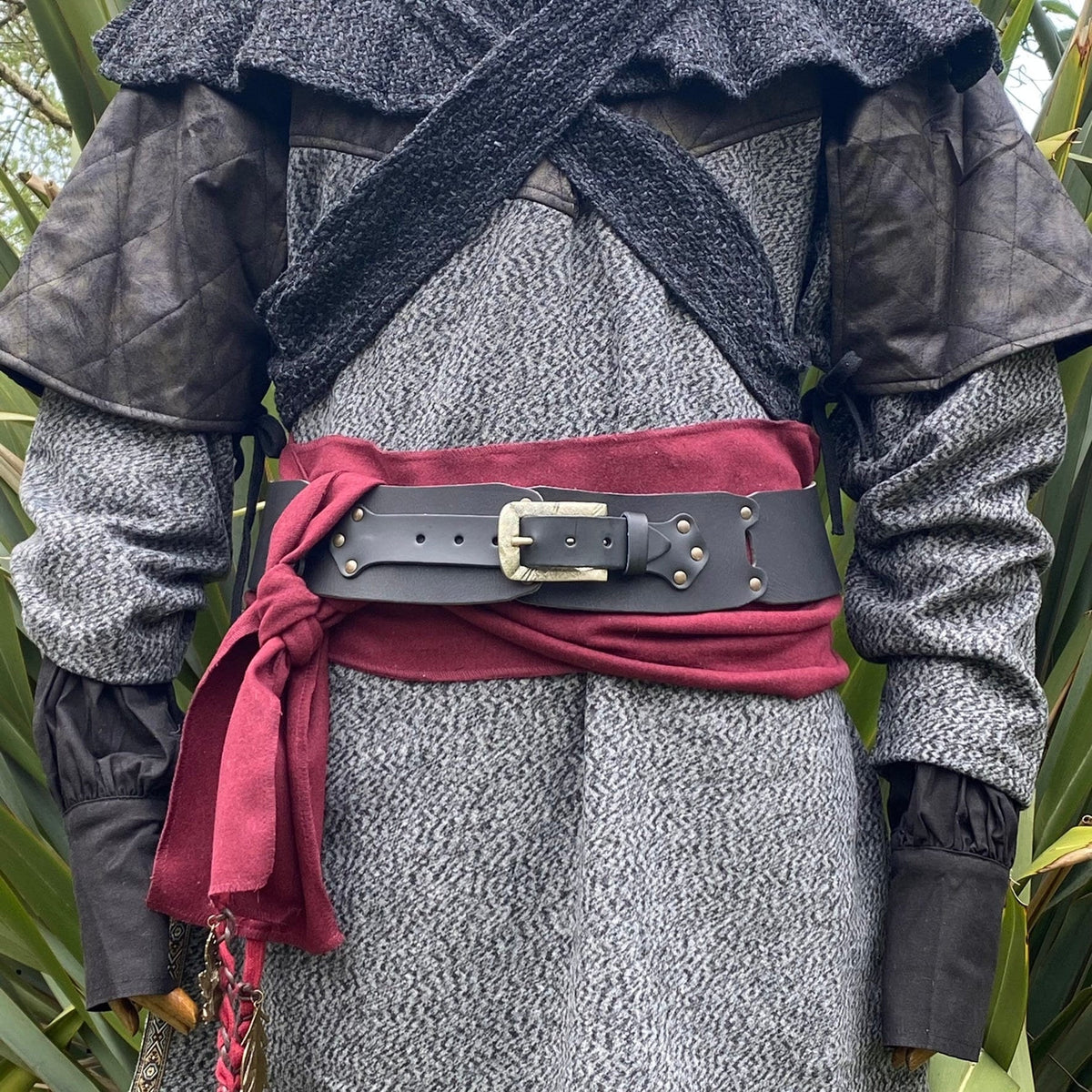 Black LARP belt in front view with burgundy sash on medieval costume.