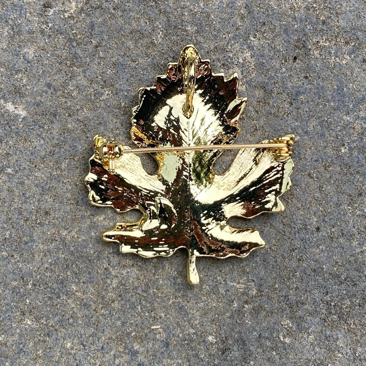 Gold elven leaf brooch back view on stone; for LARP.