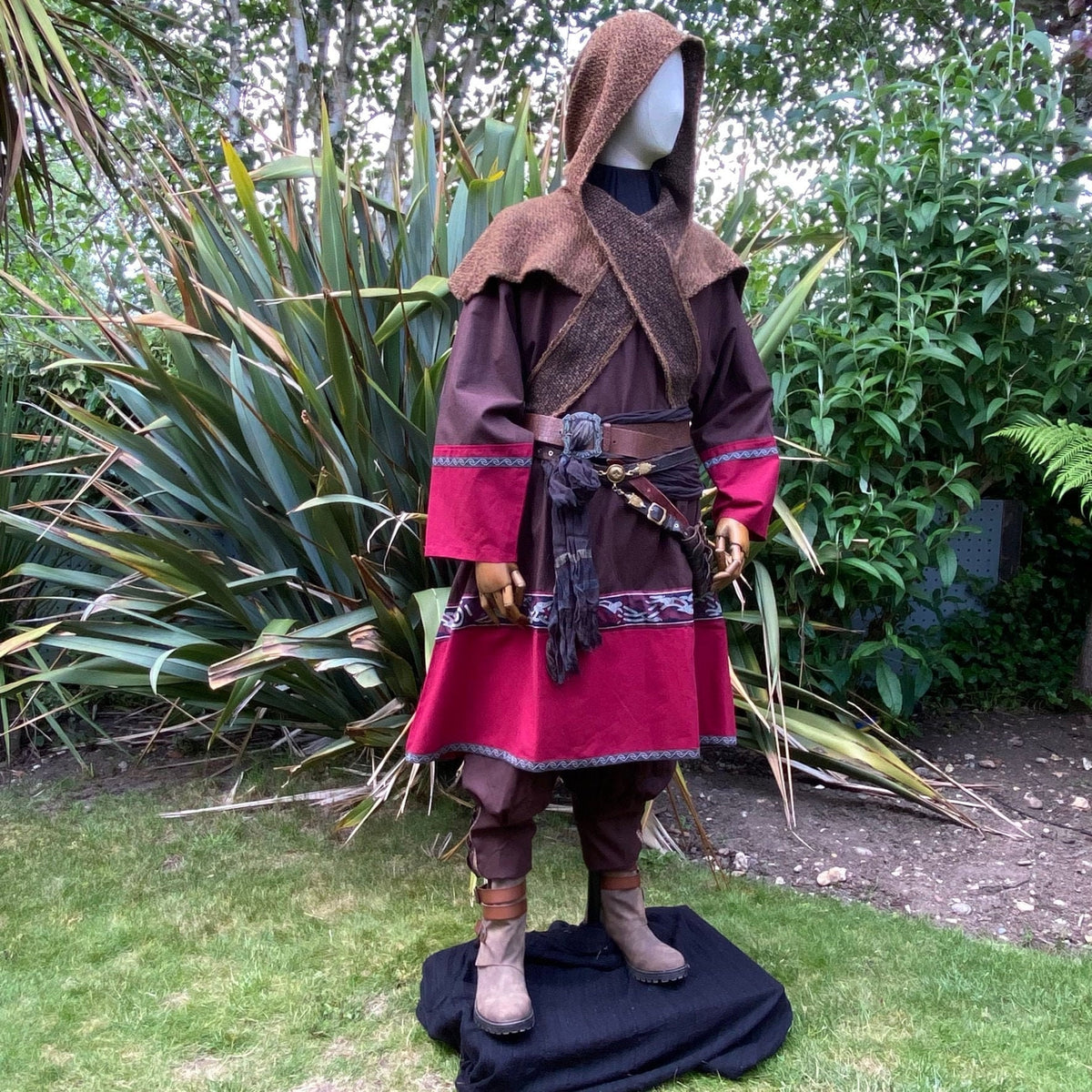 Medieval LARP outfit side view, featuring a brown and red Viking tunic, wrap around hood and.