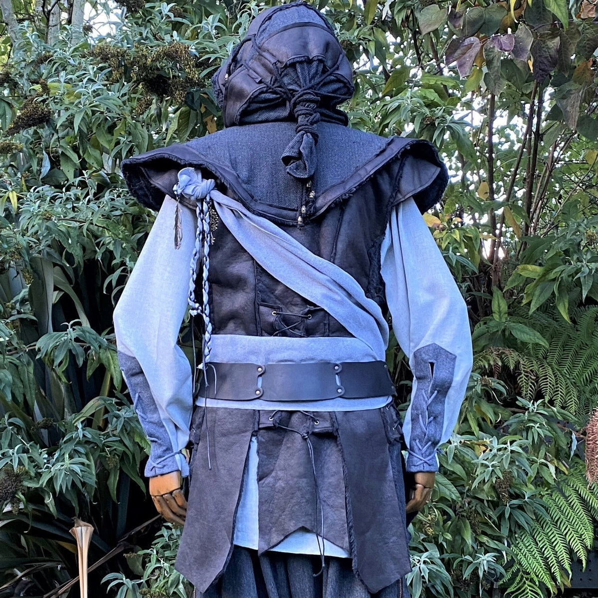 Medieval LARP outfit back view, featuring a black hood and waistcoat, grey cotton shirt, and sash.