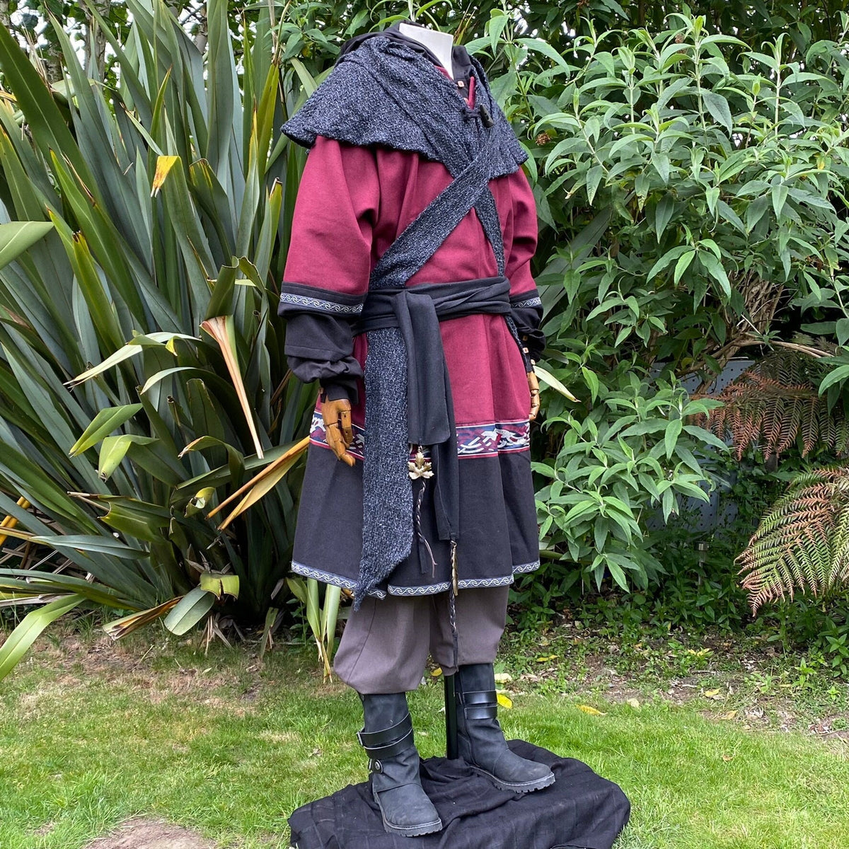 Medieval LARP outfit with red tunic and black accents, side.
