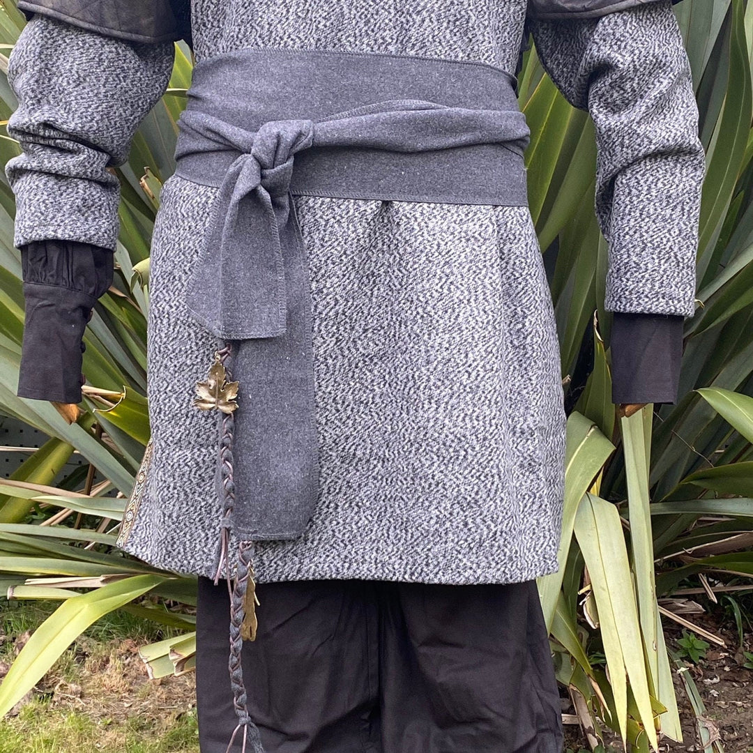A Dark Grey Wool LARP Sash. The Viking Sash is a Woollen sash that works well by itself, or underneath a LARP Belt. The LARP Sash is 300cm long, and can comfortably wrap around you. The Medieval Sash has a decorated metal accessories that adds to your LARP Character, Cosplay, or Ren Faire event.