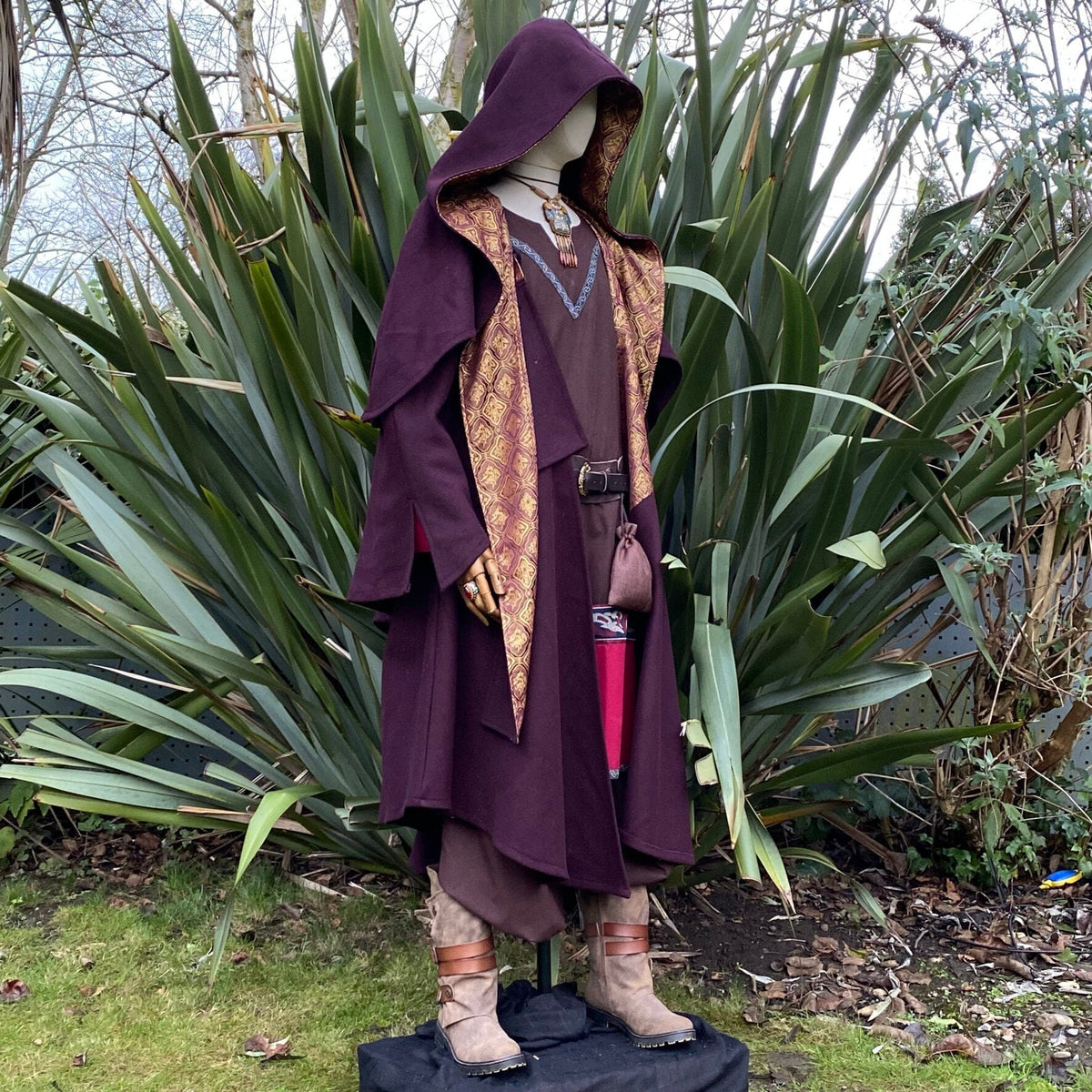Angled front view of dark red cloak with gold lining, three-layer medieval fantasy cosplay.