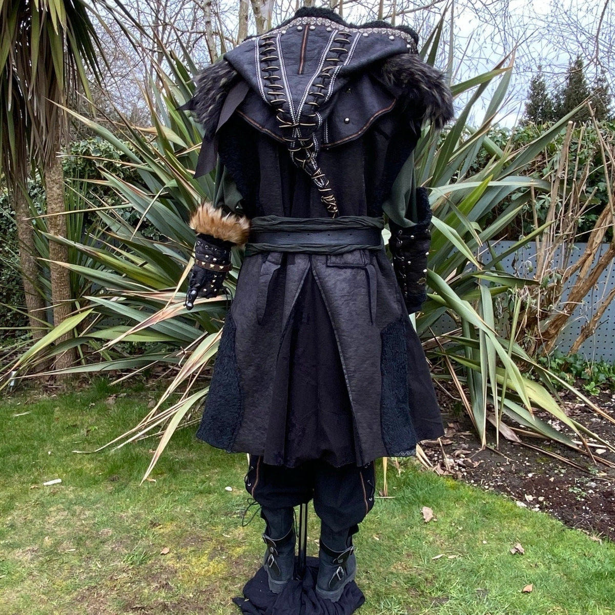 Back view of medieval LARP outfit with fur trim, belt and hood detailing.