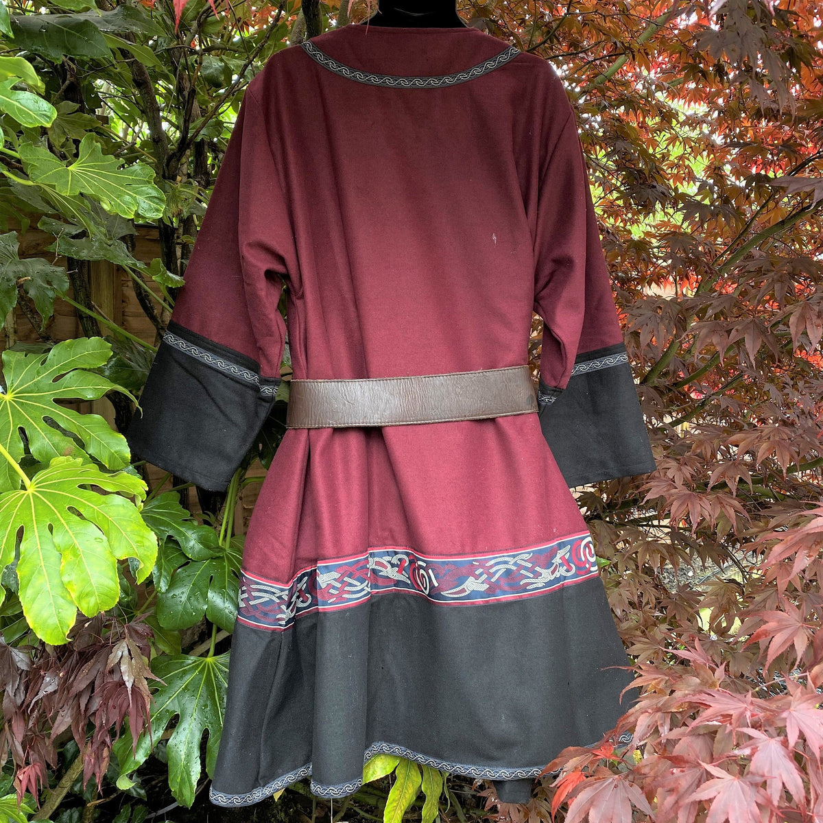 Red and black Viking tunic back view with belt, LARP costume.