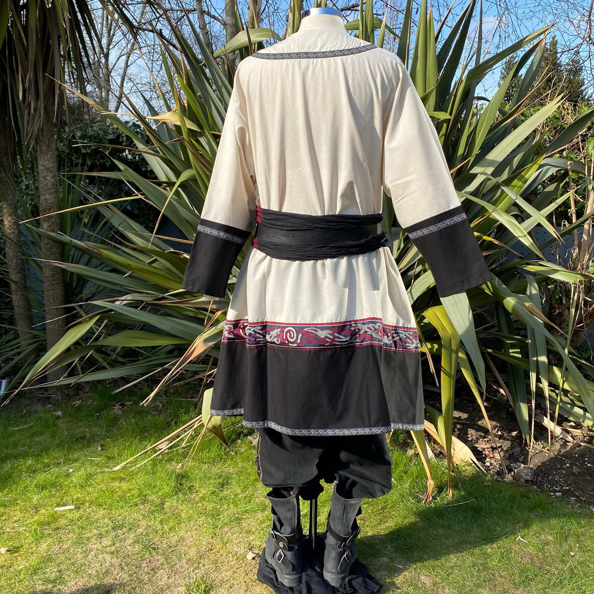 Rear view LARP medieval outfit, detailed trim on tunic, sash, trousers and boots.