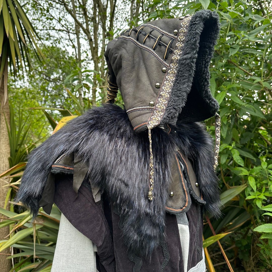 This Ornate LARP Hood in Black Faux Leather has a Faux Fur Mantle in Black & Blue. This Viking Hood is Water Resistant towards rain. The Medieval Hood covers your shoulders and provides warmth. This LARP Hood has metal Clasps, perfect for your LARP Character and LARP Costume, Cosplay Event, and Ren Faire.
