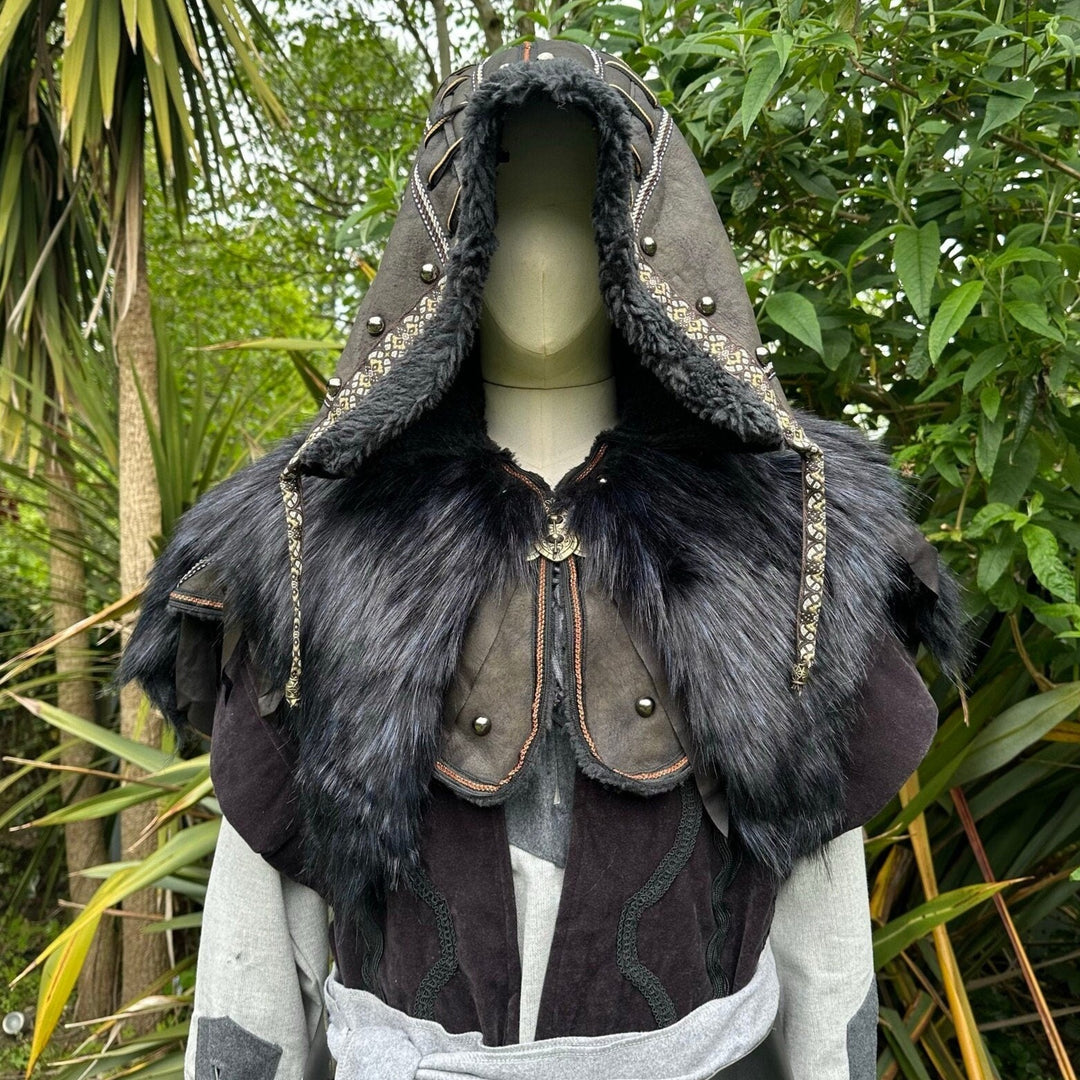This Ornate LARP Hood in Black Faux Leather has a Faux Fur Mantle in Black & Blue. This Viking Hood is Water Resistant towards rain. The Medieval Hood covers your shoulders and provides warmth. This LARP Hood has metal Clasps, perfect for your LARP Character and LARP Costume, Cosplay Event, and Ren Faire.