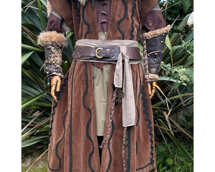 A LARP Belt and Costume Sash Set. The LARP Belt is made from Buffalo Leather in Brown. The Viking Sash is a Brown & White Herringbone Wool sash that works well by itself, or underneath the LARP Belt. The Medieval Sash has a decorated metal accessories that adds to your LARP Character, Cosplay, or Ren Faire event.